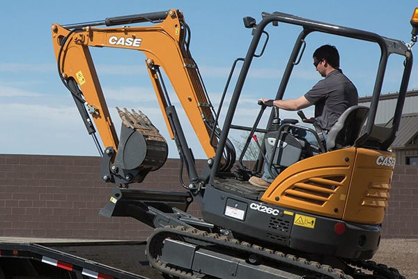 Mini excavator loading on a trailer