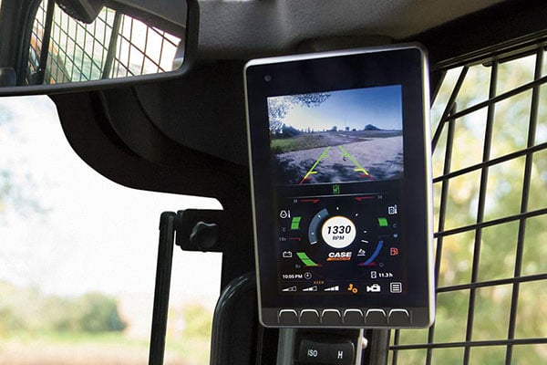 Skid steer screen shows backup camera and critical information