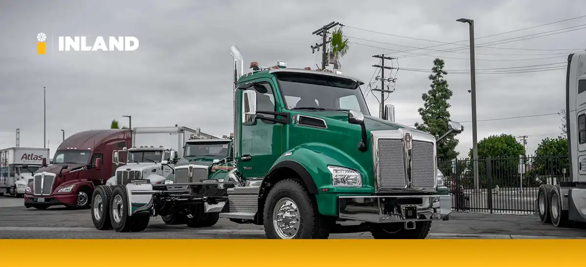 your-guide-to-building-a-budget-friendly-truck-fleet A green Kenworth T880 at an Inland Kenworth dealer.